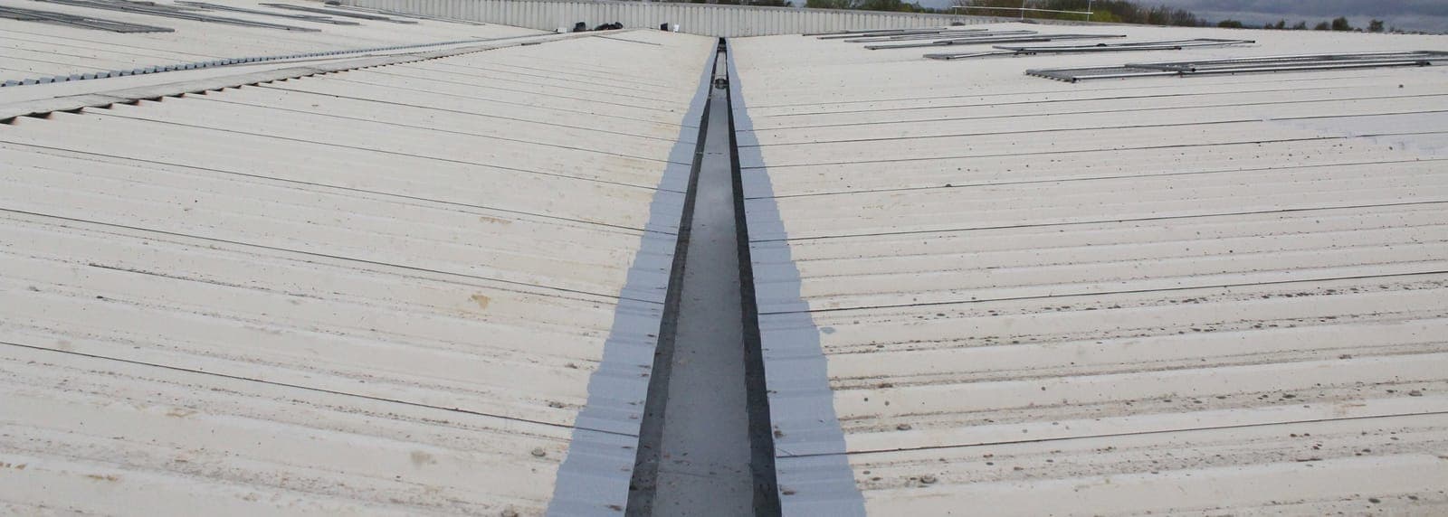 Seamless guttering running the length of a long roofline with no visible joints